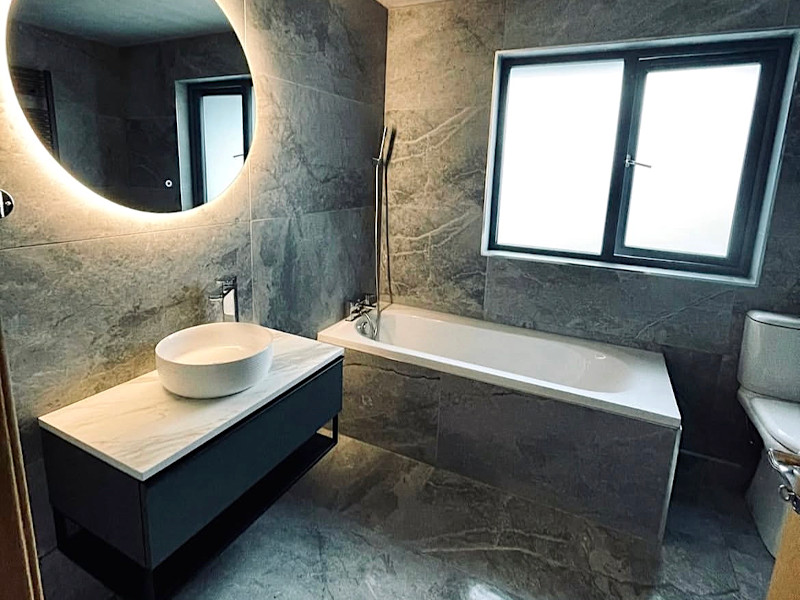 a newly renovated bathroom done by sr bathroom and tiles